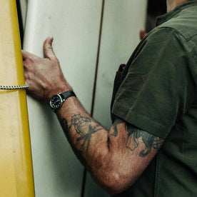 out fit model wearing The Short Sleeve Bandit in Olive—sleeve shot