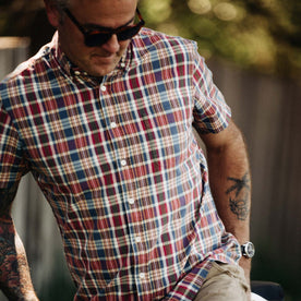 Fit model looking down and reaching into back pocket