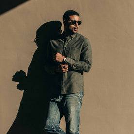 our fit model wearing The Jack in Olive Slub Chambray—against a wall