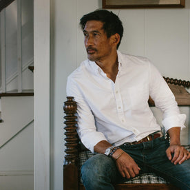 fit model wearing The Jack in White Everyday Oxford, sitting, looking left of camera