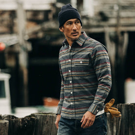 fit model rocking The Moto Shirt in Blanket Stripe, walking near dock
