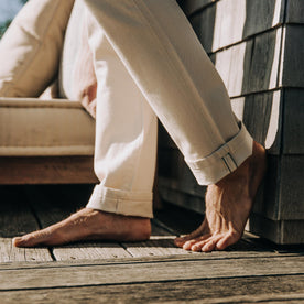 fit model showing selvage hem of The Slim Jean in Natural Organic Selvage