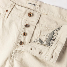 material shot of open button fly of The Slim Jean in Natural Organic Selvage