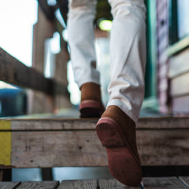 fit model wearing The Trench Boot in Butterscotch Weatherproof Suede, walking up stairs