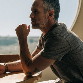 our fit model wearing The Short Sleeve Bandit in Tobacco Hemp, sitting back, close up shot