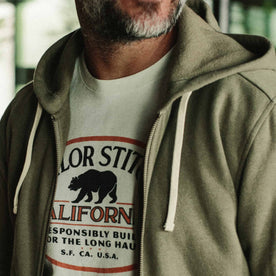 our fit model wearing The Après Hoodie in Olive—cropped of chest