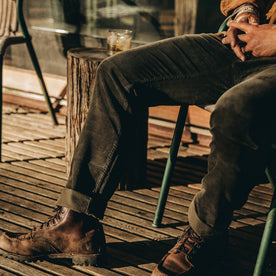 our fit model wearing The Camp Pant in Olive Corduroy—cropped shot with boots on