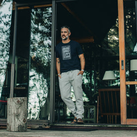 our fit model wearing The Heavy Bag Tee in Retro Block Print—looking outside