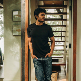 our fit model wearing The Heavy Bag Tee in Black—looking right