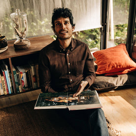 our fit model relaxing in The Jack in Brushed Rust Oxford—reading a book