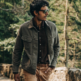 our fit model wearing The Long Haul Jacket in Moss Brushed Reverse Sateen—looking left