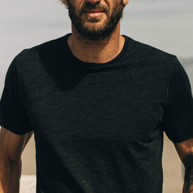 our fit model wearing The Merino Tee—in our black tee looking straight on, cropped shot