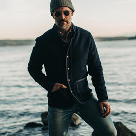 our fit model wearing The Port Jacket in Indigo Sashiko—looking at camera near water