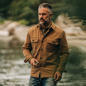 our fit model wearing The Shop Shirt in British Khaki Boss Duck—near a creek