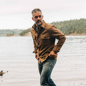 our fit model wearing The Shop Shirt in British Khaki Boss Duck—walking left of screen