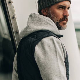 our fit model wearing The Vertical Vest in Charcoal—side shot