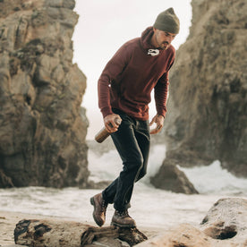 fit model wearing The Chore Pant in Coal Boss Duck, on beach, holding water container