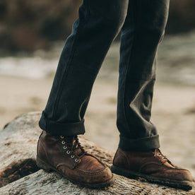 fit model wearing The Chore Pant in Coal Boss Duck, cuffed with boots