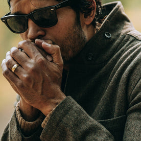 fit model wearing The Gibson Jacket in Olive Herringbone Wool, warming hands