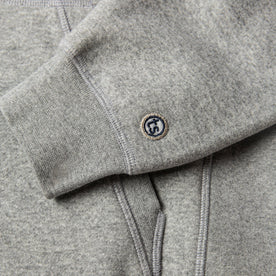 material shot of The Heavy Bag Hoodie in Heather Grey Fleece's ribbed cuff with TS logo embroidery