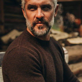 our fit model wearing The Lodge Sweater in Chocolate—looking left, cropped shot