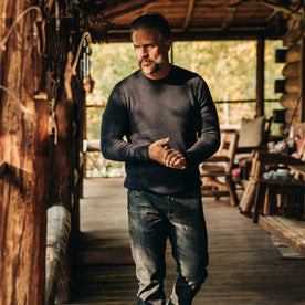 our fit model wearing The Lodge Sweater in Navy—walking on deck