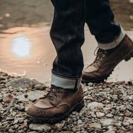 fit model wearing The Slim Jean in Cone Mills Reserve Selvage, cuffed shot over boots