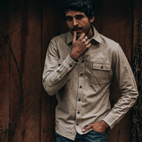 fit model wearing The Yosemite Shirt in Oat Donegal—standing near barn