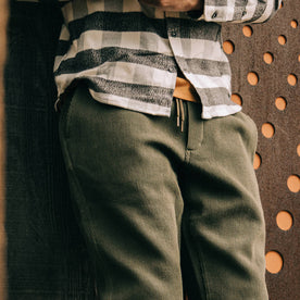 fit model wearing The Après Pant in Army Waffle, up close arm crossed