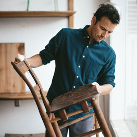 Patric looking over the chair he made