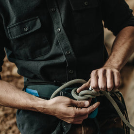 The fit model preparing his harness for rock climbing