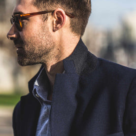 Fit model with a popped collar and sunglasses