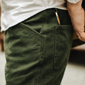 Our fit model wearing The Camp Pant in Dark Olive Tuff Duck from Taylor Stitch.