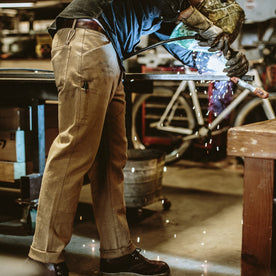 Our fit model wearing The Chore Pant in British Khaki Tuff Duck from Taylor Stitch.