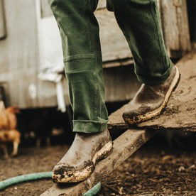 Our fit model wearing The Chore Pant in Dark Olive Tuff Duck from Taylor Stitch.