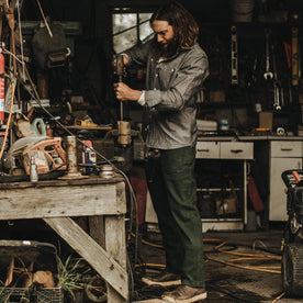Our fit model wearing The Chore Pant in Dark Olive Tuff Duck from Taylor Stitch.