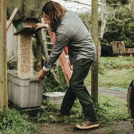 Our fit model wearing The Chore Pant in Dark Olive Tuff Duck from Taylor Stitch.