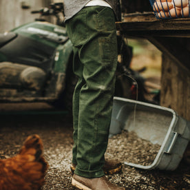 Our fit model wearing The Chore Pant in Dark Olive Tuff Duck from Taylor Stitch.