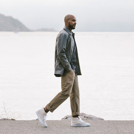 Alex walking along the shore side in the Primrose Jacket