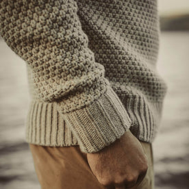 Our fit model next the water wearing our fisherman sweater