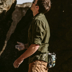 Our fit model planning out his bouldering route