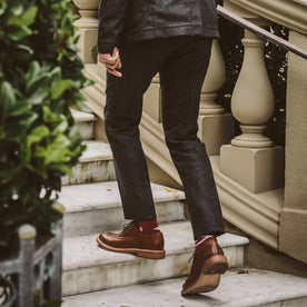 Our fit model walking up stars in his Telegraph Trousers
