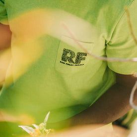 fit model showing front chest pocket of The Heavy Bag Tee in Chlorophyll