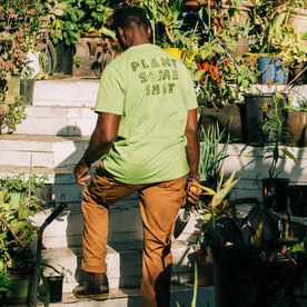 fit model showing back print of The Heavy Bag Tee in Chlorophyll