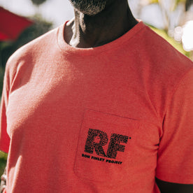 fit model showing front printed chest pocket of The Heavy Bag Tee in Hibiscus