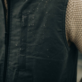 fit model with water on The Anchorage Vest in Charcoal Dry Wax