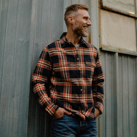 fit model wearing The Ledge Shirt in Rust Plaid with hands in pocket