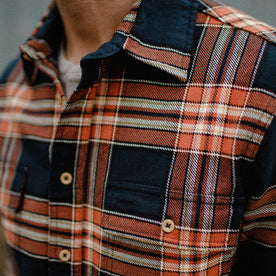 fit model wearing The Ledge Shirt in Rust Plaid showing chest pocket