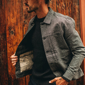 fit model wearing flatlay of The Dispatch Jacket in Navy Jaspe, holding right pocket
