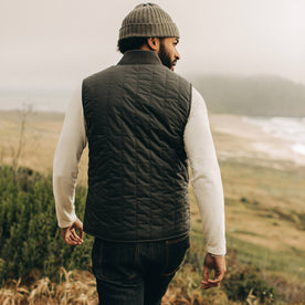 fit model wearing The Able Vest in Quilted Charcoal, back shot